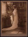 [Standing bride holding bouquet]