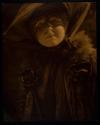 [Woman in hat with veil]