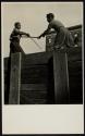 [Boys playing with wooden swords]
