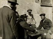 In the summer the life of the people spreads out into the street: a game of Spanish checkers