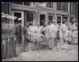 [Time exposure: People walking in and out of building]