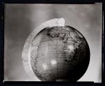 [Study: Dime rolling along circumference of globe]