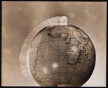 [Study: Dime rolling along circumference of globe]