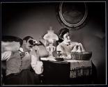 [Saturday Evening Post, historical re-creation of couple in parlor, man is looking at stereo photograph in viewer and woman does needlepoint. BBDO Agency (Batten Barton, Durstine & Osborn)]