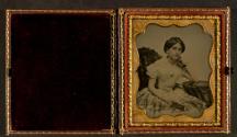 [Woman holding book]