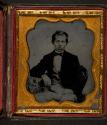 [Boy, seated, with gold ring]