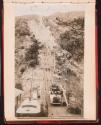 People standing on lift with attendant all having picture taken. Mt. Lowe Railway?