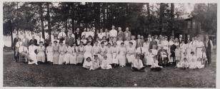 [Group posed outdoors, possibly a family picnic]
