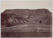 [View of river in front of rocky mountains]