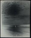 [Figure on beach]