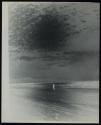 [Figure on beach]