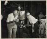 [Victor Keppler and assistant directing a photo shoot]