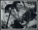 [man's feet inside of pressurized glass tubes]