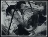 [man's feet inside of pressurized glass tubes]