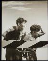 [U.S. Steel, two boys and dog standing at railroad crossing]