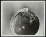[dime circling globe]