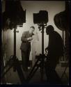 [man removing lightbulb from lamp, Keppler making photograph]