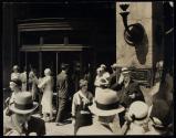 [sidewalk scene outside of Macy's department store]