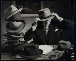 [Employer's Group, man trying on hats]