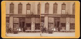 [View of Lovejoy's storefront, display of stereo views in window]