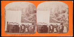 [Group of people (some identified) in front of photographer Andrew Price's tent]