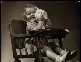 [girl in high chair with bowl]