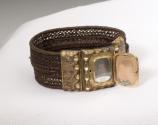 [Small daguerreotype portrait of man with bracelet made of human hair]