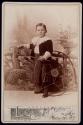 [Child with hoop toy]