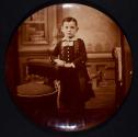 [Boy in long coat with decorative collar]