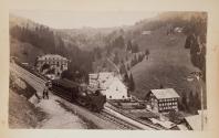 [Train driving through the mountains]