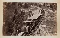 [Train driving through the mountains]