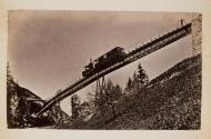 [Train on bridge as seen from below]