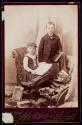 [Girl and boy with photographic memorabilia]