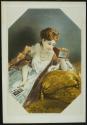 [Elegant woman looking at stereo cards in a viewer]