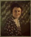 [Smiling woman in flowered dress]