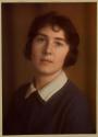 [Young woman in dark dress with white collar (head and shoulders)]