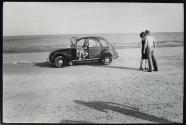 [Couple on beach with automobile]