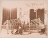 [Mosque interior with two coffins and a man worshipping]