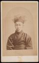 [Asian man wearing headpiece]