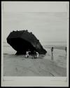 [Children playing under landing craft at Omaha Beach, Normandy France]