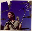 [Linda Joan Martin standing with husk of corn at Umpawaug, CT]