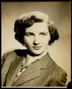 [Woman in a striped suit]