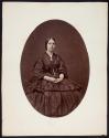[Seated woman with crinolines under skirt]