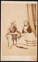 [Scene of courtship: Man holding hat and looking at the woman seated next to him holding flowers]