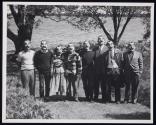 [Group of seven men and one woman, all wearing rubber "Victor Keppler" masks]