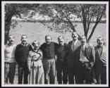 [Victor Keppler with group of six men and one woman, all wearing rubber "Victor Keppler" masks]