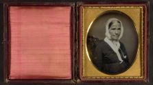 [Elderly woman in white bonnet, dark dress with white collar (head and shoulders)]