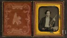 [Young man holding violin and bow]
