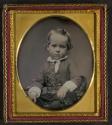 [Child with curls and a ruffled collar]