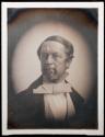 [Man wearing glasses, large white bow tie, paisley vest]